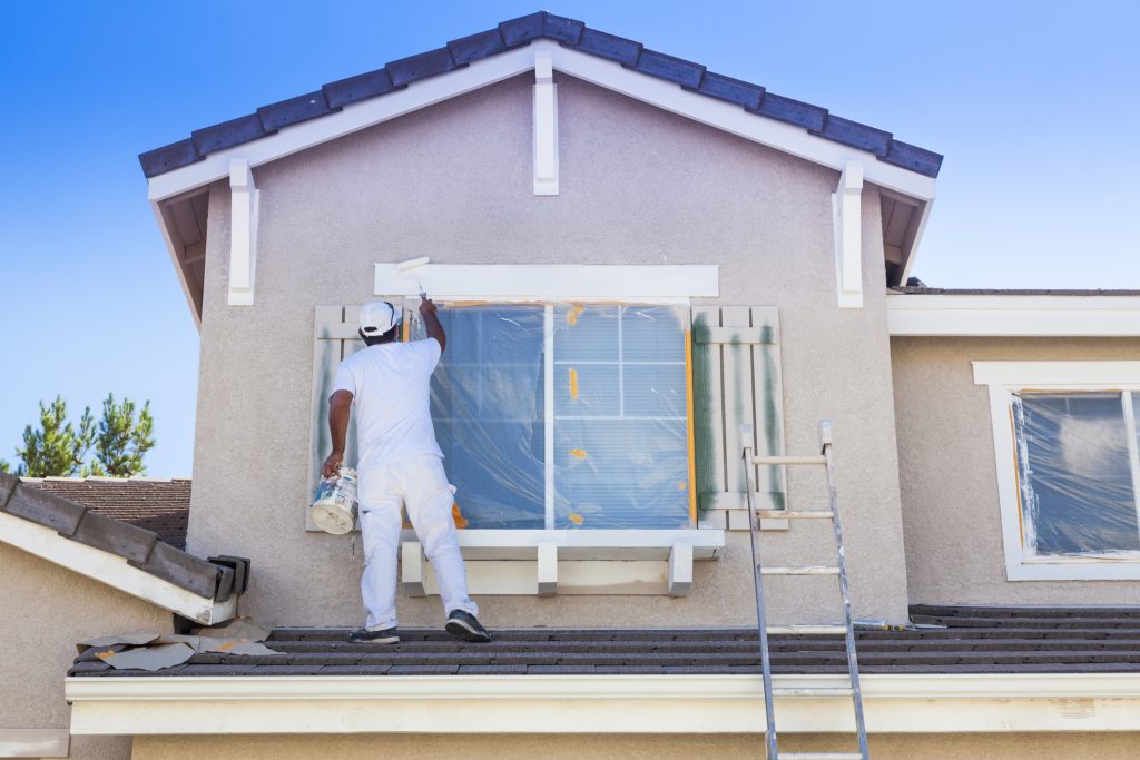 Exterior Painting on window trim and shutters, being done by painter